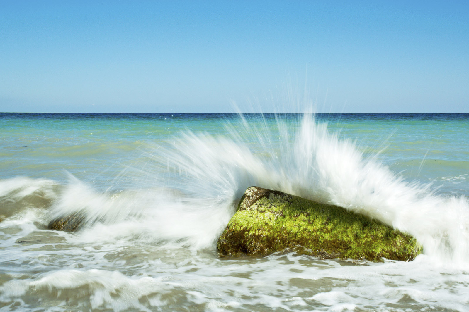 Wave hits rock
